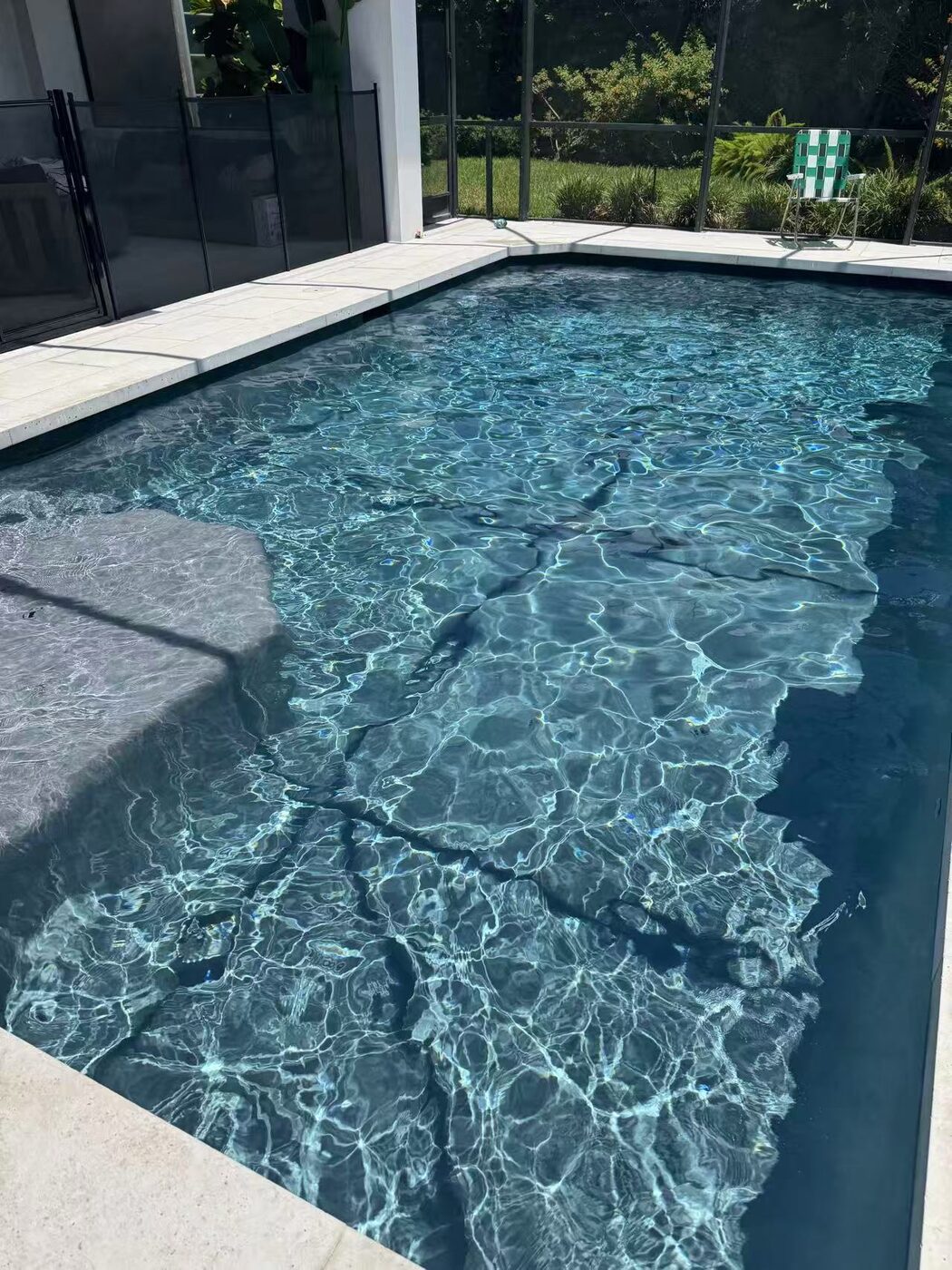 Modern dark-tile pool maintained weekly by Florida Floyd Pool Services